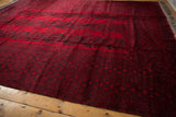 Angled view showcasing the repeating Bokhara guls on the deep red field of an Ersari carpet.