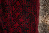 Full, dense cherry red pile and original selvage on a vintage Afghani Ersari design carpet.