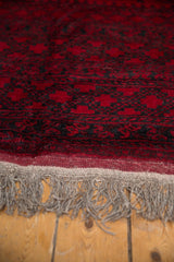 Detailed view of the vintage carpet's full pile and original hand-knotted wool fringe.