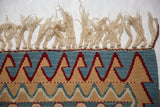 Natural ivory fringe, original side cord selvages, and geometric wave motif on a vintage Turkish Kilim rug.
