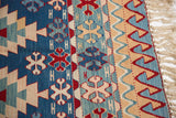 Hand woven vintage Turkish Kilim rug end with a rolling wave motif and natural fringe.