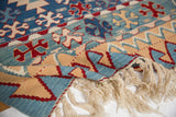 Natural creamy fringe, flat weave, and denim blue, sand, red wave motif on vintage Kilim.