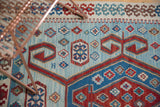 A vintage Turkish Kilim rug's flatweave texture showing geometric patterns and powder blue abrash.