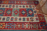Paneled gul motifs and flatweave texture of a vintage Turkish Kilim rug in red, blue, ivory.