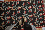 Turkish Kilim featuring germinating plant motifs in charcoal, wine red, apricot, powder blue.