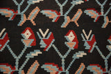 Hand-woven Turkish Kilim's germinating plant motif in charcoal, wine red, and powder blue.
