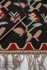 Fringe and geometric red, beige, powder blue border of a vintage Turkish Kilim rug.