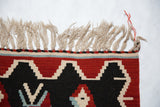 Hand woven Turkish Kilim rug fringe and charcoal black, wine red germinating plant motif.
