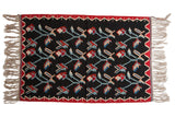 Hand woven Vintage Turkish Kilim rug with Bessarabian plant motifs in black, red, and blue.