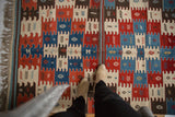 Vintage Turkish Kilim with finned geometric motifs in natural indigo blue, cherry red, ivory.
