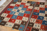 Vintage Turkish Kilim rug corner: natural dye geometric blocks with snowflake and arrow motifs.