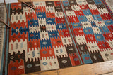 Vintage Turkish Kilim rug corner, geometric paneled design in natural red, blue, ivory, brown.
