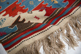 Fringed end of vintage Turkish Kilim rug showing natural dyes and geometric details.