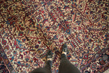 Full pile texture of a vintage Mehrivan carpet with interconnected red and blue leaves and vinery.