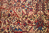 Intricate palmettes and vinery in cherry red and navy blue on the plush pile.