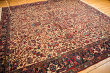 Angled full view of the vintage Mehrivan rug, showing its intricate allover pattern and wide navy border.