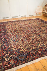 The vintage Mehrivan carpet's dense floral pattern and square shape, viewed from an angle on a floor.
