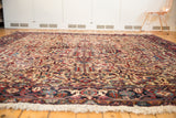 A low-angle view of the vintage Mehrivan rug showing its full pile and allover design.