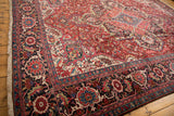 A vintage Ahar carpet's corner showing the plush pile and wide Herati-style main border.