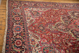 Corner detail of the Persian Ahar rug's intricate Herati border in navy blue and red.