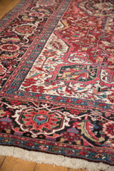 A vintage Ahar carpet's border with detailed Herati and samovar designs in red and blue.
