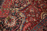 A detailed look at the vintage Ahar carpet's wide border with samovar and Herati motifs.