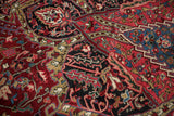 Hand-knotted pile showing delicate vinery and florals in cherry red, navy, and beige.