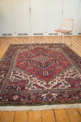 Vintage Persian Heriz carpet showcasing traditional geometric forms on a madder red field.