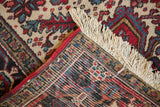 Hand-knotted foundation, red side cord, and fringe on a vintage Persian Heriz carpet corner.