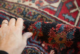 The even, original pile and substantial body of a vintage Persian Heriz carpet.