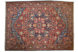Antique Persian Bakshaish carpet with a large geometric medallion in jewel tones of ruby red and sapphire blue.