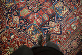 Dense pile and vibrant, large-scale geometric palmettes of an antique Persian Bakshaish carpet.