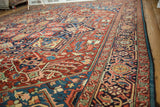 Angled view across the plush wool pile of a collectible Bakshaish carpet with gem-toned geometric patterns.
