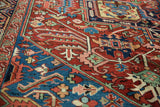 Close view of an antique Bakshaish carpet's intricate vinery in vivid ruby and sapphire jewel tones.