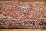 Low-angle view of a vintage Heriz carpet highlighting the dense pile and starburst medallion.