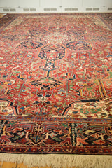 Low-angle view of a vintage Heriz carpet's plush, full pile and detailed geometric field design.