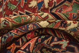 The lush, even wool pile and intricate hand-knotted detail of a vintage Heriz carpet.