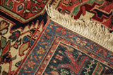 Original ivory fringe and hand-knotted foundation on the corner of a vintage Heriz carpet.