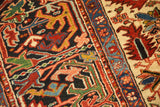 Dense, like-new wool pile showing the geometric floral motifs of a vintage Persian Heriz carpet.