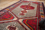 Cherry red medallion on finned camel and sand geometric ground of vintage Serab runner.