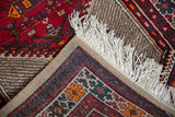 Vintage Serab runner corner with white fringe, geometric patterns, and hand-woven foundation.
