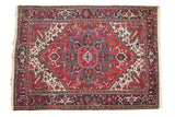 Vintage Persian Mehrivan carpet with a floral medallion design in cherry red, navy blue, and ivory.