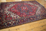 Vintage Persian Mehrivan carpet showing its bold medallion and floral field in red, navy, and ivory.