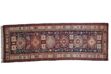 Vintage Ardebil rug runner with oversized geometric medallions in red and blush on a navy blue ground.