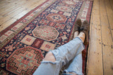 Repeating Caucasian-inspired geometric medallions run the length of this vintage Ardebil Persian runner.