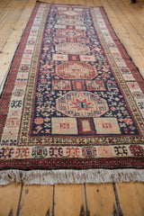 Angled shot showing the length and Caucasian-style medallions of a vintage Ardebil runner.