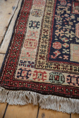Detail of the vintage Ardebil runner's original side cord selvage, geometric border, and full pile.