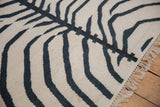 Textured hand woven vintage Kilim rug with ivory and charcoal navy zebra stripes and fringe.