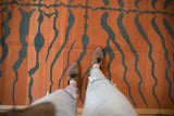 Pale rust and dusty teal tiger stripe pattern with abrashes on vintage hand woven kilim.