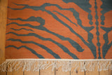 Vintage Indian Tiger Kilim's distinct rust and teal tiger stripes with cream fringe.
